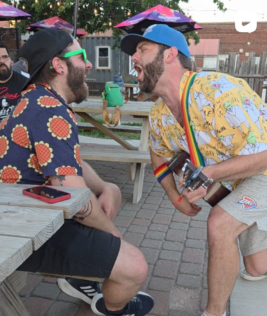 Artist and crowd member singing their hearts out during an outdoor patio Wednesday Wave concert